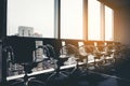 Row of modern black chair in empty office space with large window view cityscape, vintage picture style process, business meeting Royalty Free Stock Photo