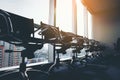 Row of modern black chair in empty office space with large window view cityscape, vintage picture style process, business meeting