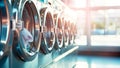 A row of modern, efficient washing machines in a bright laundromat. Ease of self-service laundry. Energy-efficient cleaning Royalty Free Stock Photo