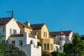 Row of modern houses in the historic districts of downtown san francisco california with front yard trees and blue sky Royalty Free Stock Photo