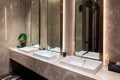 Row of modern marble ceramic wash basin in public toilet, restroom in restaurant or hotel or shopping mall, interior decoration