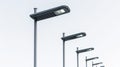 Row of modern solar street lights against a clear sky, showcasing sustainable urban lighting technology Royalty Free Stock Photo