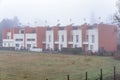 Row of modern terraced houses on a foggy winter day