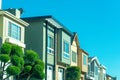 Row of modern townhomes or houses in sunlit neighborhood or residential area of the suburban city downtown Royalty Free Stock Photo