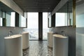 Row of modern white ceramic wash basin in public toilet with cit Royalty Free Stock Photo