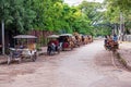 Motor bikes with attached carts on a street in Siem Reap, Cambodia.