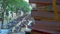 A row of motorcycles lined up neatly in a large courtyard, with a view from behind a book.