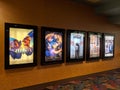 Row of movie posters including Papillon, the House with a Clock in it`s Wall, Peppermint, The Bookshop, and Puzzle on wall locate