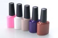 A row of multi-colored bottles with nail Polish on a white table Royalty Free Stock Photo