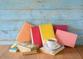 Row of multicolored hardback books and cup of coffee, reading education, literature Royalty Free Stock Photo