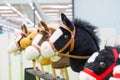 Row of multicolored hobbyhorses - children toys Royalty Free Stock Photo