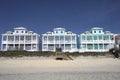 Row of multicolored houses on a sandy beach Royalty Free Stock Photo