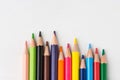 Row of multicolored rainbow palette pencils on white wood background. School art education kids creativity concept. Poster banner