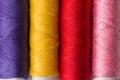 Row of multicolored rainbow palette sewing threads on cardboard spools. Crafts hobbies local artisan business interior decoration