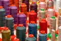 Row of multicolored thread spools at sewing factory Royalty Free Stock Photo