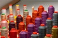 Row of multicolored thread spools at sewing factory Royalty Free Stock Photo