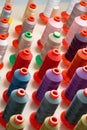 Row of multicolored thread spools at sewing factory Royalty Free Stock Photo