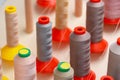 Row of multicolored thread spools at sewing factory Royalty Free Stock Photo