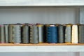 Row of multicolored thread spools at sewing factory Royalty Free Stock Photo