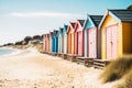 Row of multicolored wooden beach huts sand blue sky. Summer vacation relaxation concept