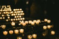 Multiple candles light in a row in Strasbourg Notre-Dame cathedral during