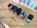 Row of multiple colorful Apple Computers Watch Series 7 smart IOT devices with