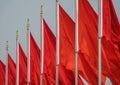 A row of national red chinese flags with yellow stars