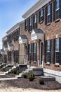 Row of new brick attached homes in newly constructed subdivision with shutters and front steps Royalty Free Stock Photo