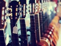 Row of new acoustic guitars in music shop Royalty Free Stock Photo