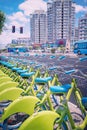 Row of new green public sharing bicycle lined up on the street