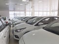 Row of new white sedan cars at car dealer showroom Royalty Free Stock Photo