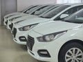 Row of new white sedan cars at car dealer showroom Royalty Free Stock Photo