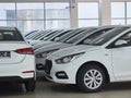 Row of new white sedan cars at car dealer showroom Royalty Free Stock Photo