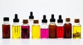 A row of nine small glass bottles containing various colored liquids is displayed