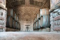 Row of oak barrels in a dry cool wine cellar Royalty Free Stock Photo