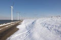 Row offshore windturbines along Ductch coast in winter with snow Royalty Free Stock Photo