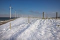 Row offshore windturbines along Ductch coast in winter with snow Royalty Free Stock Photo