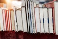 Row of old aged books at flea market. Vintage retro literature print on display table outdoors. Street swap meet