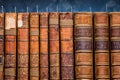 Row of old antique books in a library Royalty Free Stock Photo