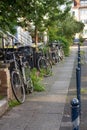 Row of old bicycles on city street. Urban transport concept. Healthy lifestyle concept. Parking retro bikes. Royalty Free Stock Photo