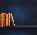 Row of old books on black shelf. Square background Royalty Free Stock Photo