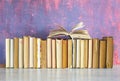 Row of old books, one open,background or web banner free copy space.Reading, education, literature, book fair concept Royalty Free Stock Photo