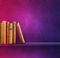 Row of old books on purple shelf. Square background Royalty Free Stock Photo