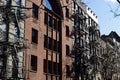 Row of Old Brick Apartment Buildings with Fire Escapes along a Residential Street in Greenwich Village of New York City Royalty Free Stock Photo