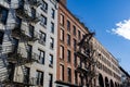 Row of Old Brick Apartment Buildings with Fire Escapes along a Residential Street in Greenwich Village of New York City Royalty Free Stock Photo