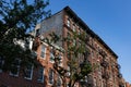 Row of Old Brick Apartment Buildings with Fire Escapes in the West Village of New York City Royalty Free Stock Photo