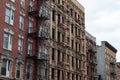 Row of Old Brick Apartment Buildings in Greenwich Village of New York City with Fire Escapes Royalty Free Stock Photo