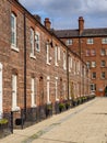 row of old brick built terraced house in the north of England Manchester, with black iron railings outside Royalty Free Stock Photo