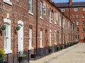 row of old brick built terraced house in the north of England Manchester, with black iron railings outside Royalty Free Stock Photo