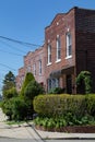 Row of Old Brick Homes with Beautiful Spring Gardens in Astoria Queens New York Royalty Free Stock Photo